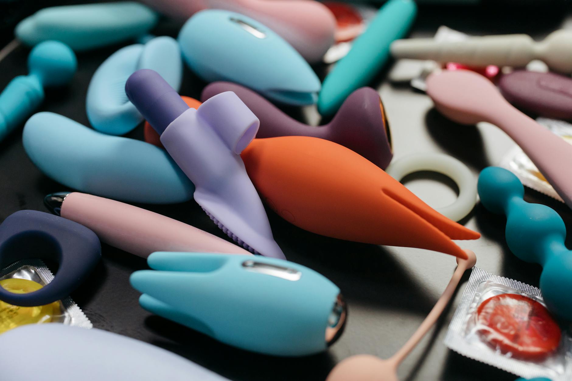 Close-up collection of various lemon and pastel vibrators arranged together