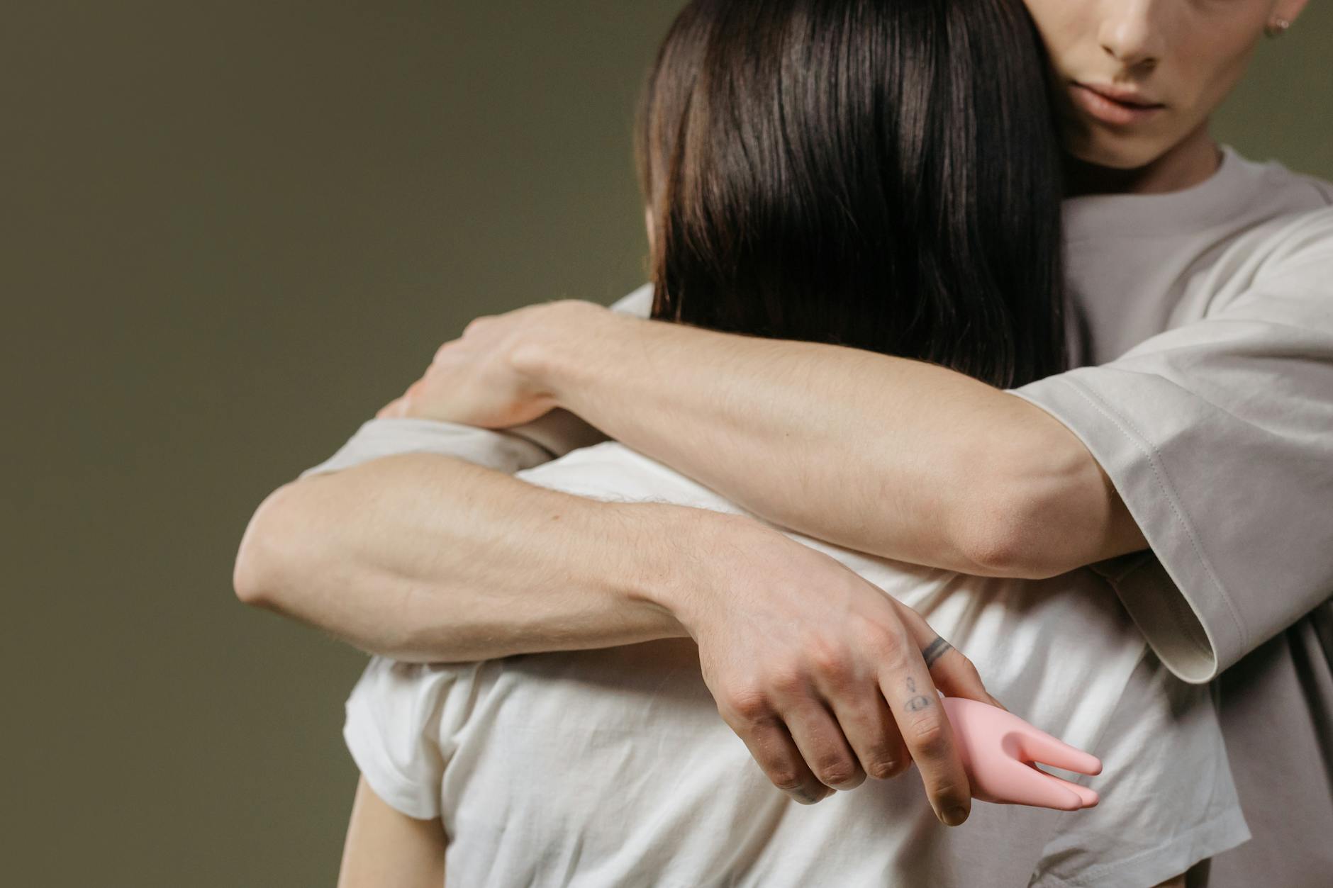 An intimate close-up of a couple embracing, highlighting the connection and vulnerability that comes with shared exploration.