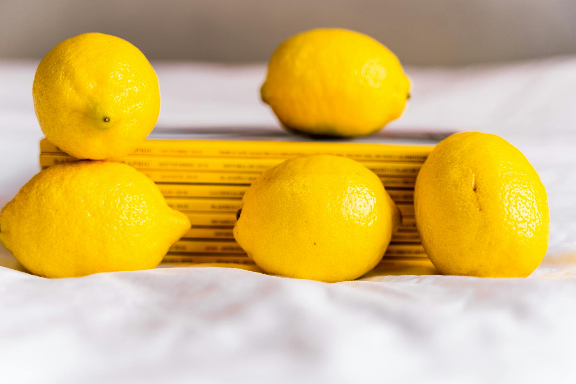 Two women laughing together with lemon slices, expressing joy and comfort
